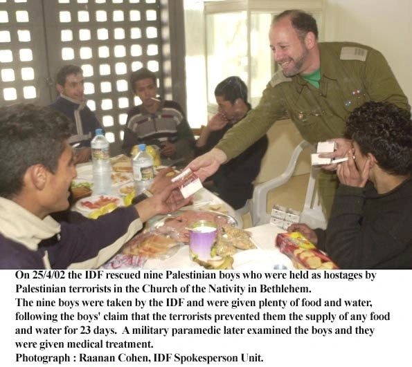 IDF officer serving food to Palestinian boys at the Church of the Nativity